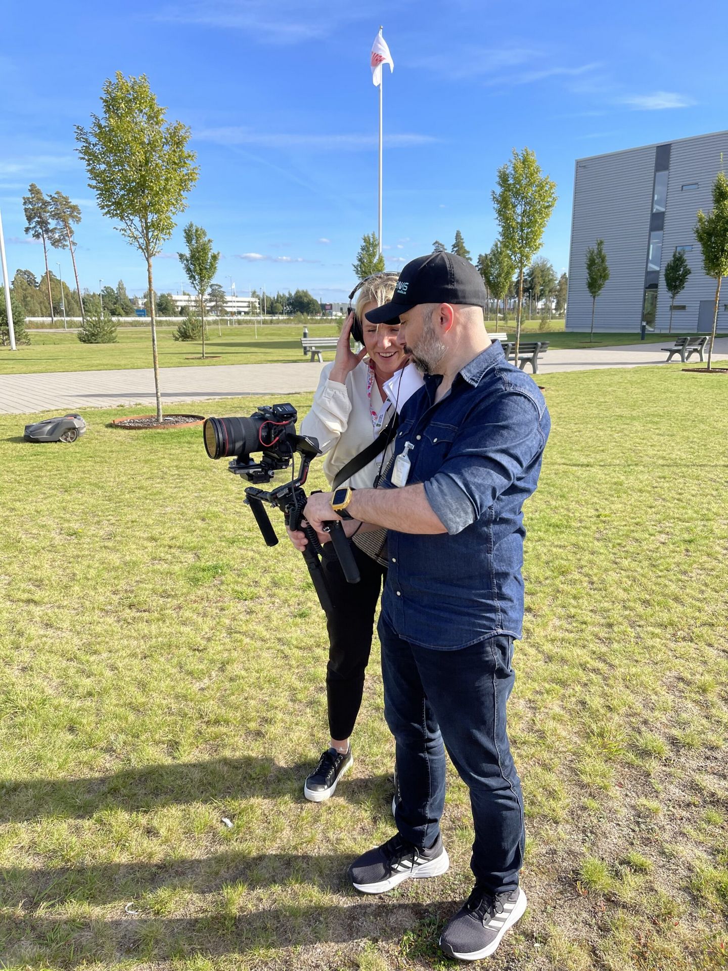 The film crew reviewing footage on the camera outdoors