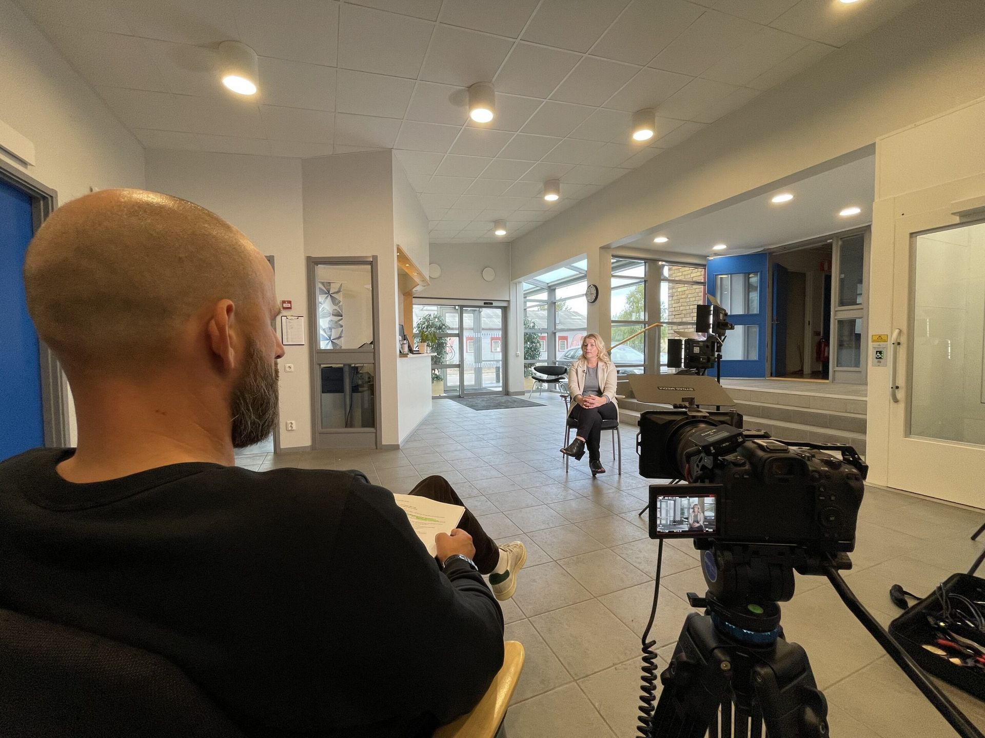 Interview setup in an entrance hall with a camera and teleprompter